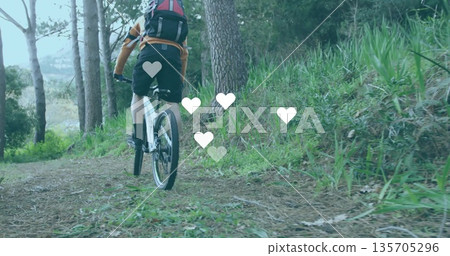 Riding male cyclist navigating pine-needle trail in forest, with mountain bike, helmet and backpack 135705296
