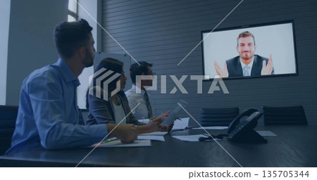 Colleagues sitting in boardroom viewing call with printed docs, pens, speakerphone, display screen Colleagues sitting in boardroom viewing call with printed docs, pens, speakerphone, display screen 135705344