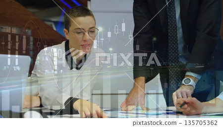 Leaning glasses-wearing European woman reviewing charts at desk with laptop, pen and graph overlays Leaning glasses-wearing European woman reviewing charts at desk with laptop, pen and graph overlays 135705362