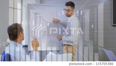 Pointing presenter in business attire showing market data on conference flip chart, with overlays Pointing presenter in business attire showing market data on conference flip chart, with overlays 135705366
