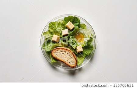 Groceries In Petri Dish. A scientific petri dish, shot from directly above on a clean white lab bench, contains not 135705631