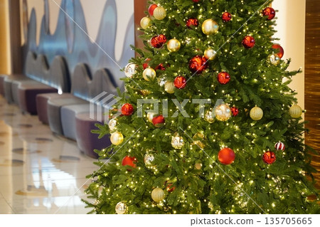 Christmas tree with decorations in the lobby of the hotel Christmas tree with decorations in the lobby of the hotel 135705665