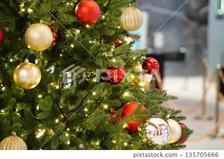 Festive Christmas Tree with Red and Gold Ornaments 135705666