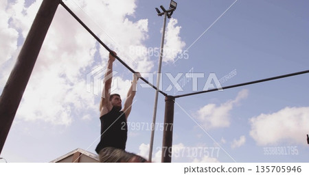 Pulling athlete gripping bar at gym by building corner, light pole, numeric overlays copy space Pulling athlete gripping bar at gym by building corner, light pole, numeric overlays copy space 135705946