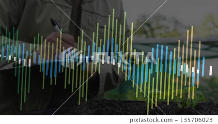 Writing man in tan jacket taking notes on greenhouse bench, with seedling and data overlay 135706023