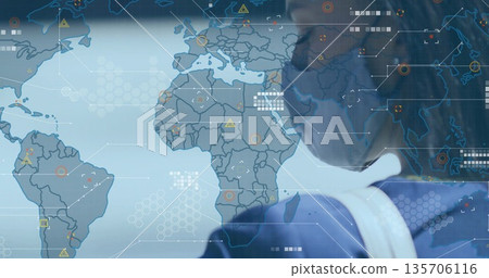 Analyst wearing face mask standing in control room, with world map and hex grid, copy space Analyst wearing face mask standing in control room, with world map and hex grid, copy space 135706116