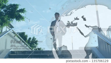 Ascending Asian businessman climbing stairs at plaza, with suitcase, bag and globe overlay Ascending Asian businessman climbing stairs at plaza, with suitcase, bag and globe overlay 135706129