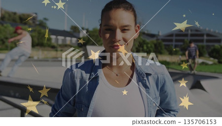 Standing facing camera wearing denim shirt in skatepark, with moving skateboard, gold star overlay Standing facing camera wearing denim shirt in skatepark, with moving skateboard, gold star overlay 135706153