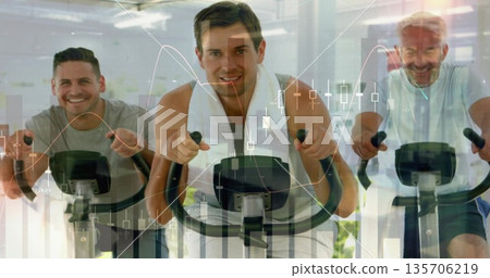 Three men in t-shirts cycling on stationary bikes in gym, with white towel, financial chart overlay Three men in t-shirts cycling on stationary bikes in gym, with white towel, financial chart overlay 135706219