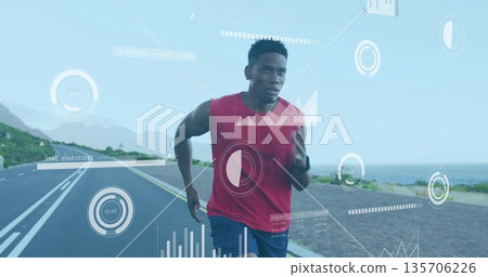 Running athlete wearing top, wrist tracker on lane-marked coastal road, displaying overlay graphics Running athlete wearing top, wrist tracker on lane-marked coastal road, displaying overlay graphics 135706226
