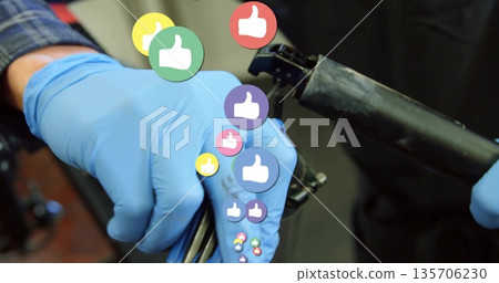 Adjusting seat post clamp with mechanic's nitrile-gloved hands in workshop, with thumbs-up graphics 135706230