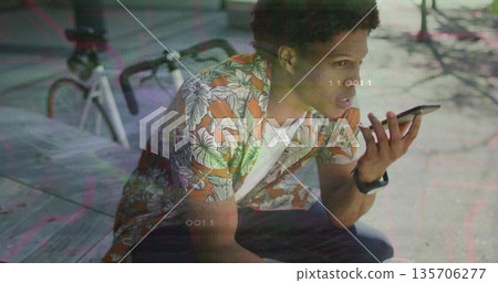 Holding smartphone man wearing floral shirt crouching on plaza with bicycle, smartwatch, overlays 135706277