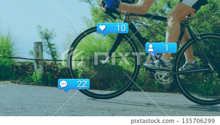 Woman cyclist wearing cycling kit pedaling along rural lane, with road bicycle and media icons 135706299