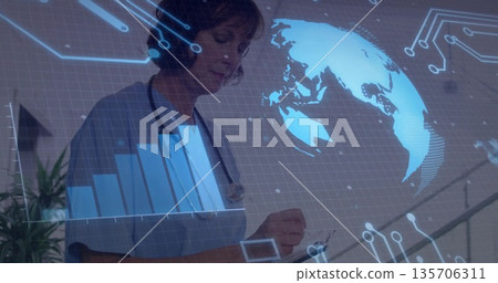 Projecting digital map and chart, scrub clad nurse using stylus at clinic desk, with stethoscope 135706311