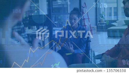 Presenting business casual woman in wheelchair showing charts in glass office with tablet overlay Presenting business casual woman in wheelchair showing charts in glass office with tablet overlay 135706338