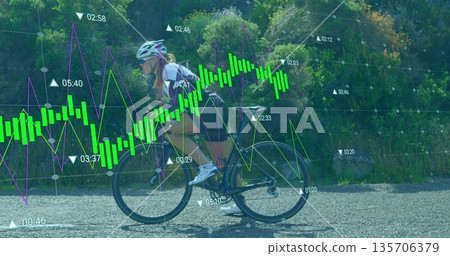 Pedaling female cyclist riding road bicycle on rural paved lane, with overlaid performance charts Pedaling female cyclist riding road bicycle on rural paved lane, with overlaid performance charts 135706379