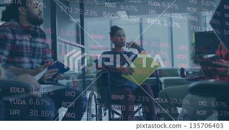 Holding yellow folder, manager in wheelchair leading discussion in conference room with tablet 135706403