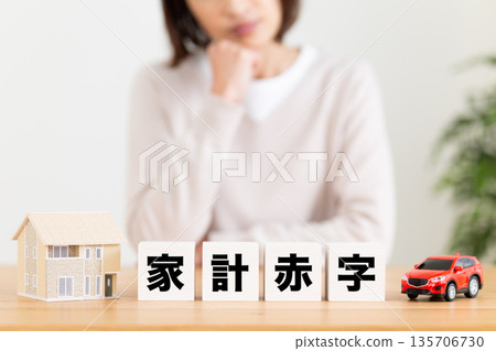 A middle-aged woman worried about her household deficit A middle-aged woman worried about her household deficit 135706730