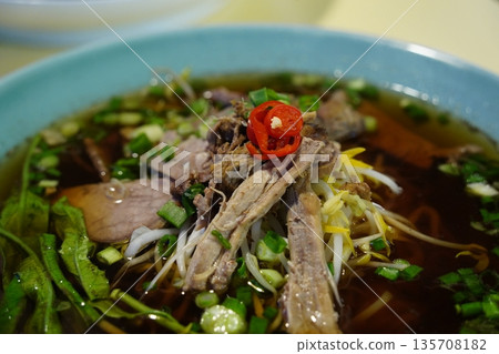Traditional Thai Duck Noodle Soup (Kuay Tiao Ped) with Shredded Meat, Bean Sprouts, and Water Spinach 135708182