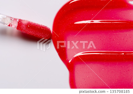 Lip oil, liquid red lipstick. Cosmetic product for lip moisturizing. Copy space 135708185