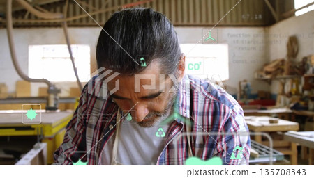 Leaning veteran craftsman scanning digital icons in woodworking workshop, with wooden planks Leaning veteran craftsman scanning digital icons in woodworking workshop, with wooden planks 135708343