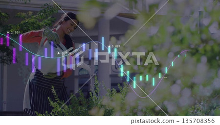 Woman wearing apron and gloves watering plants with watering can on garden veranda, graph overlay Woman wearing apron and gloves watering plants with watering can on garden veranda, graph overlay 135708356