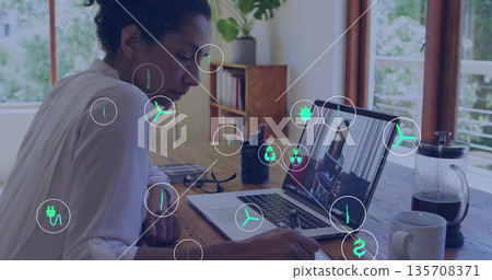 Writing woman wearing white blouse at desk by windows, with laptop and French press, copy space Writing woman wearing white blouse at desk by windows, with laptop and French press, copy space 135708371