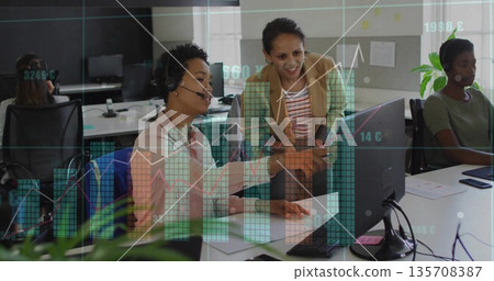 Collaborating business casual agents wearing headsets analyzing charts on monitors in call center Collaborating business casual agents wearing headsets analyzing charts on monitors in call center 135708387