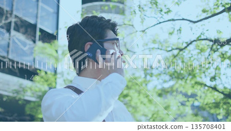 Talking businessman in suspenders and glasses holding smartphone in plaza, tech overlay, copy space Talking businessman in suspenders and glasses holding smartphone in plaza, tech overlay, copy space 135708401