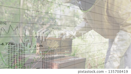 beekeeper in protective suit lifting, inspecting frame at apiary with financial overlay, copy space 135708419