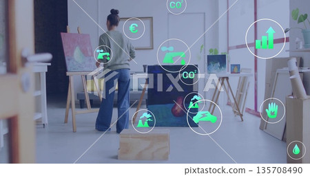 Painting woman artist painting on canvas with paintbrush at art studio, with digital overlay icons Painting woman artist painting on canvas with paintbrush at art studio, with digital overlay icons 135708490