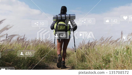 Walking female hiker carrying bright green backpack with trekking poles along rural trail, AR icons Walking female hiker carrying bright green backpack with trekking poles along rural trail, AR icons 135708572