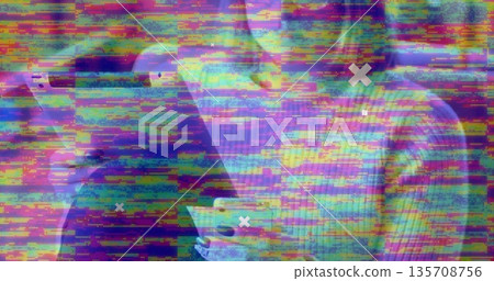Glitch overlay distorting two colleagues holding smartphones in studio, with white Xs across frame Glitch overlay distorting two colleagues holding smartphones in studio, with white Xs across frame 135708756
