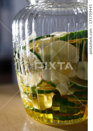 Homemade lemonade made with fresh ginger and honey | Storage jar during preparation 135709445