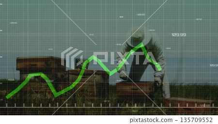 Beekeeper wearing suit and veil inspecting hive boxes and frames in meadow, with graph overlay 135709552