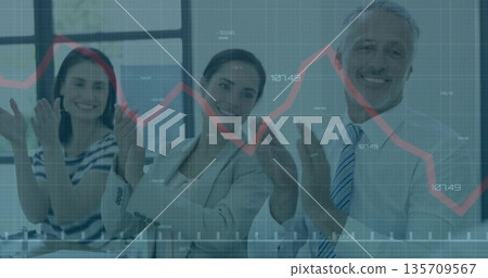 Clapping three professionals in suits reviewing financial data at conference table, graph overlay Clapping three professionals in suits reviewing financial data at conference table, graph overlay 135709567