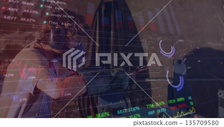 Shooter wearing protective gear aiming pistol at shooting range, overlaying financial charts Shooter wearing protective gear aiming pistol at shooting range, overlaying financial charts 135709580