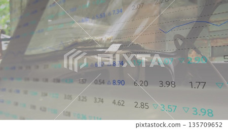 Showing car dashboard and steering wheel inside parked vehicle, with financial data overlay 135709652