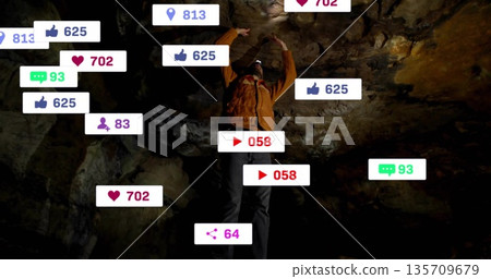 Exploring man wearing orange coat, helmet headlamp illuminating cave walls, with social media icons Exploring man wearing orange coat, helmet headlamp illuminating cave walls, with social media icons 135709679