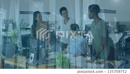 Collaborating professionals analyzing translucent data graphs in office, with monitors and papers Collaborating professionals analyzing translucent data graphs in office, with monitors and papers 135709752
