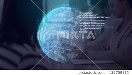 Collaborating team in suits analyzing holographic globe at meeting room with laptops and coffee mug 135709815