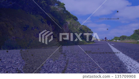 Pedaling adult female cyclist riding along rural highway, with road bicycle, helmet and sunglasses Pedaling adult female cyclist riding along rural highway, with road bicycle, helmet and sunglasses 135709908