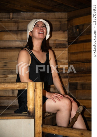 Young woman relaxing in a sauna, Yatsugatake, Yamanashi 135709913