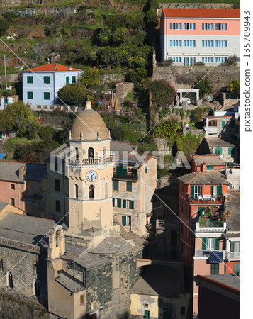 View of Vernazza, a town in Cinque Terre, from the mountain. Nature and sea, traditional buildings of Liguria, Italy. Architecture protected by UNESCO. Church of Santa Margherita. 135709943