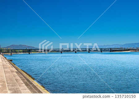 The Gustave Eiffel Bridge over the river Lima in Viana do Castelo in Portugal. Panoramic cityscape view of Viana and the Marina. The Gustave Eiffel Bridge over the river Lima in Viana do Castelo in Portugal. Panoramic cityscape view of Viana and the Marina. 135710150