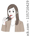 Illustration material: woman applying lipstick, woman applying makeup 135710429