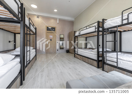 Bright hostel dormitory room with industrial black bunk beds Bright hostel dormitory room with industrial black bunk beds 135711005