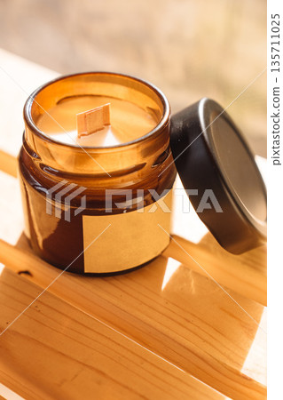 Scented candles on a wooden table.  135711025