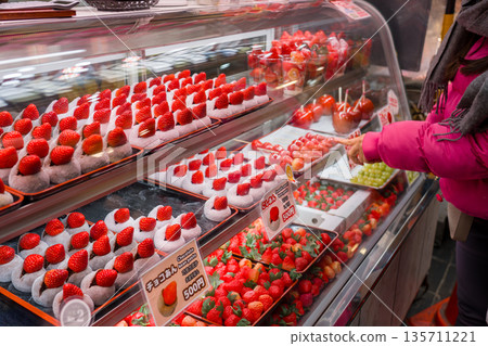A shop selling strawberry sweets at a popular Japanese market 135711221