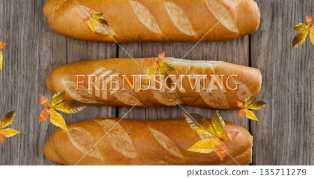 Image of friendsgiving text over fall leaves and bread 135711279